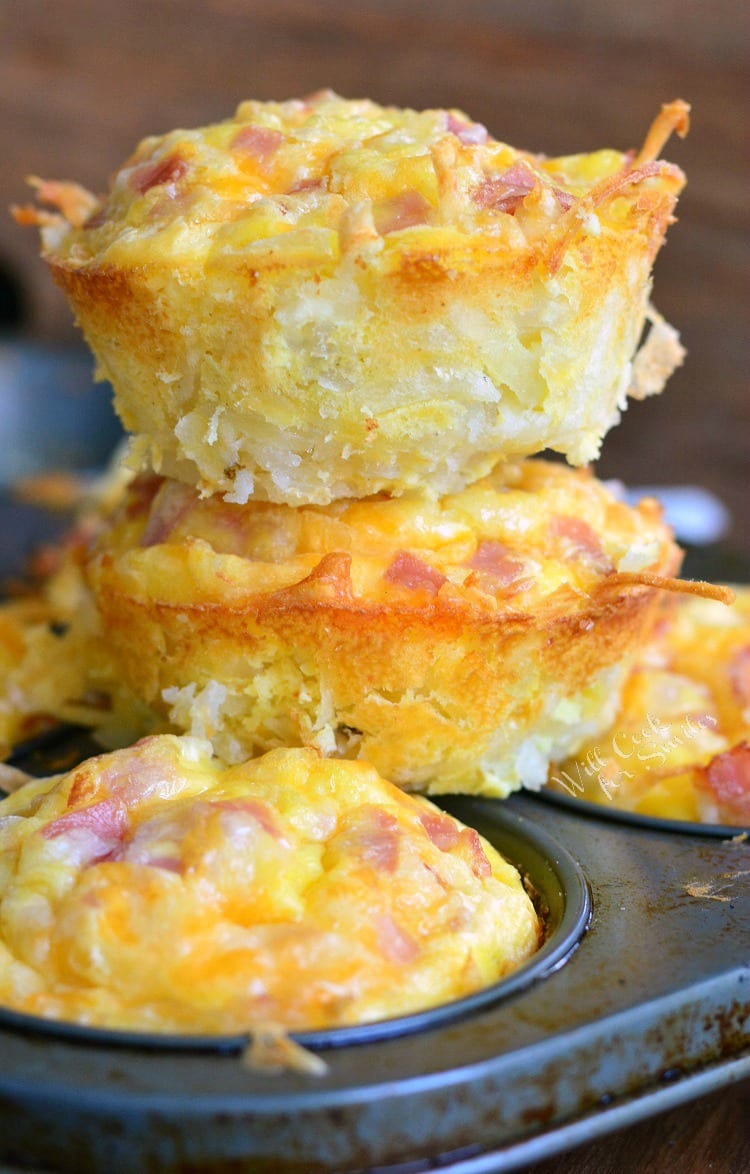 stacked hashbrown ham and egg breakfast muffins on the muffin baking pan.