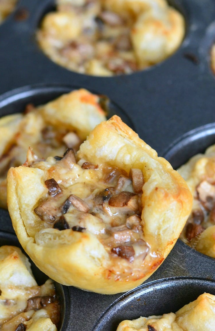easy puff pastry appetized filled with mushroom and cheese filling on the muffin pan.