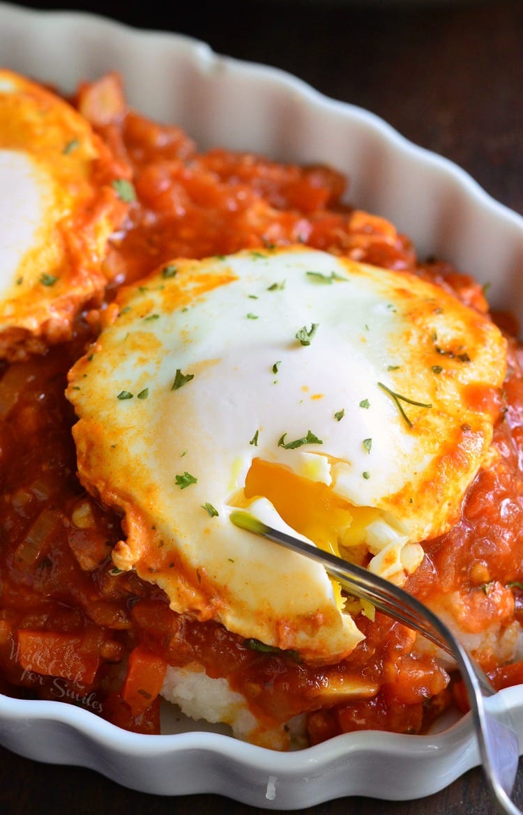 Shakshuka with Parmesan Polenta in a bowl with a fork
