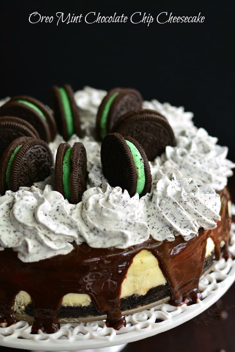Oreo Mint Chocolate Chip Cheesecake on a cake stand