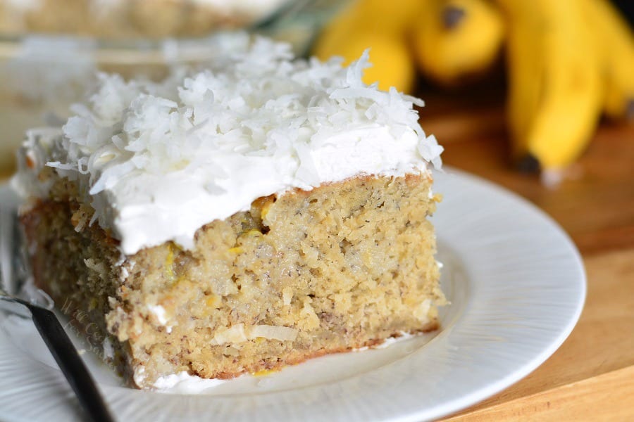 Lemon Coconut Banana Poke Cake on a plate with a fork