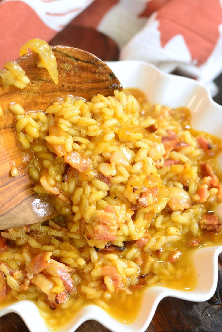 Bacon Onion and Pumpkin Risotto Recipe in a bowl with a wooden spoon