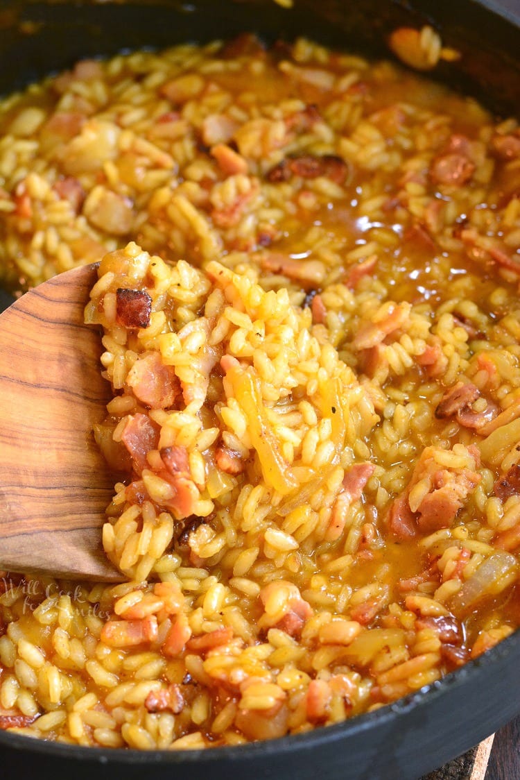 Bacon Onion and Pumpkin Risotto Recipe in a pan with a wooden spoon