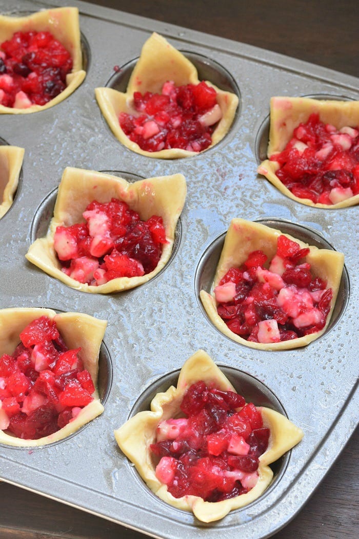 Cranberry Brie Puff Bites in a muffin tin uncooked