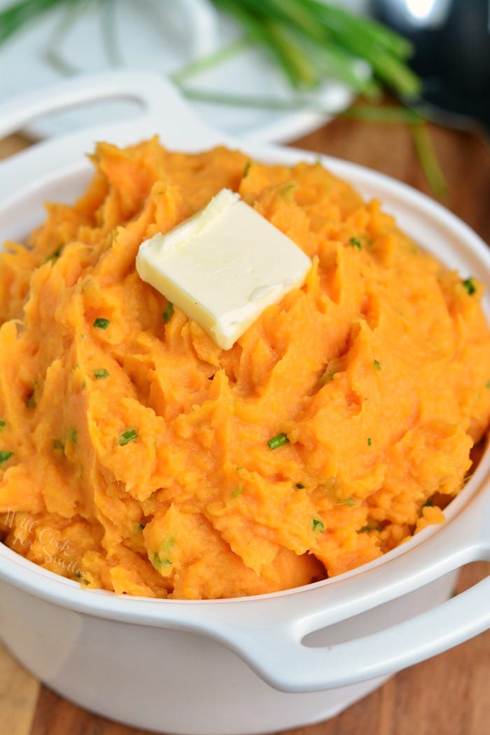 Mashed Sweet Potatoes in a serving dish with a pat of buter