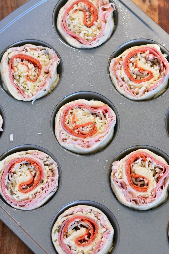 Italian Sub Pinwheels uncooked in a muffin pan to cook