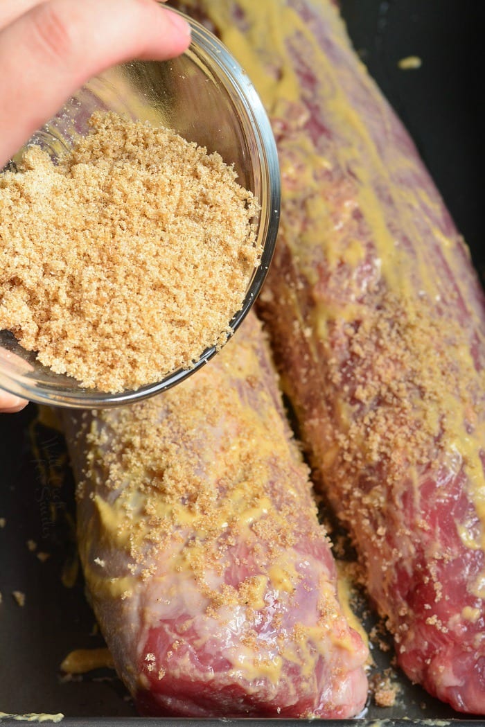 sprinkling brown sugar over Dijon mustard rubbed pork tenderloins.