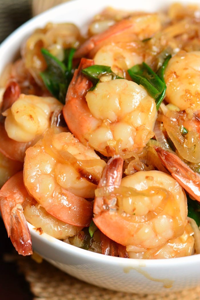 several juicy shrimp in garlic sauce over the bowl of rice.