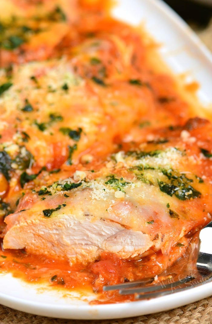 one of the light instant pot chicken parmesan chicken breasts cut in half.