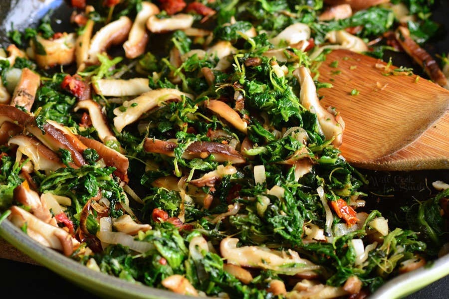 sauteed spinach and mushrooms cooked in the skillet.