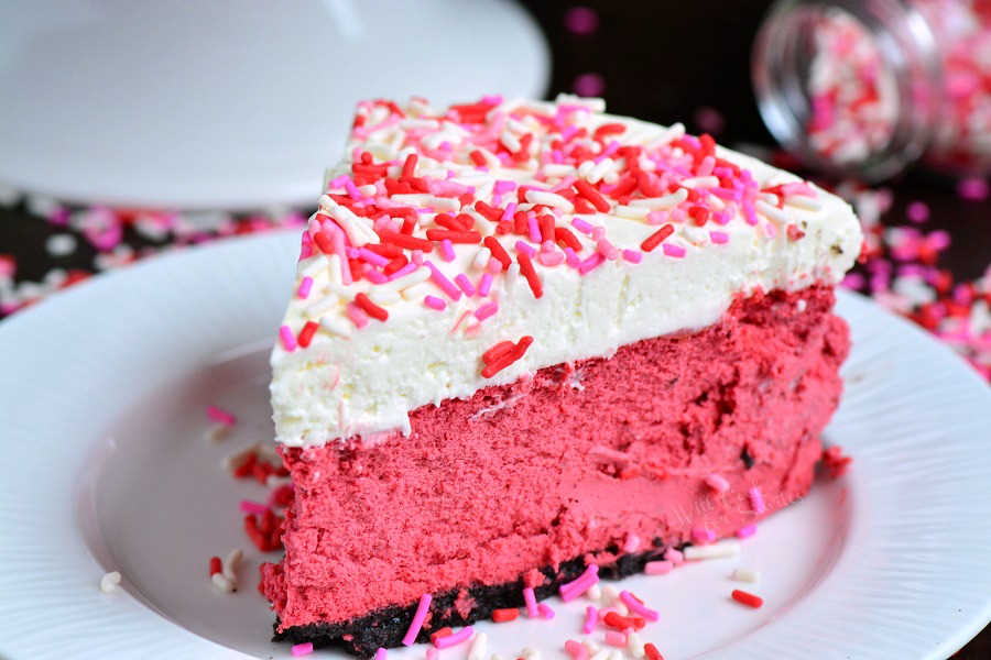Red Velvet Cheesecake. This luscious cheesecake is inspired by a traditional red velvet cake and made with buttermilk, vinegar, cocoa powder, and topped with cream cheese frosting. #cheesecake #redvelvet #dessert #frosting