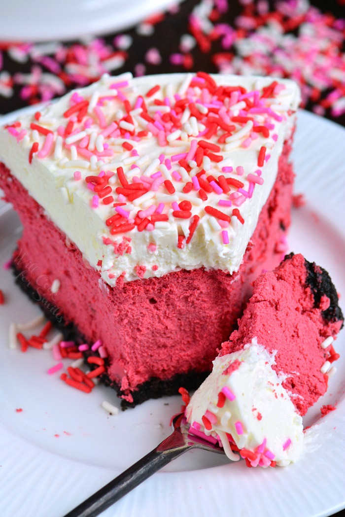 Red Velvet Cheesecake. This luscious cheesecake is inspired by a traditional red velvet cake and made with buttermilk, vinegar, cocoa powder, and topped with cream cheese frosting. #cheesecake #redvelvet #dessert #frosting