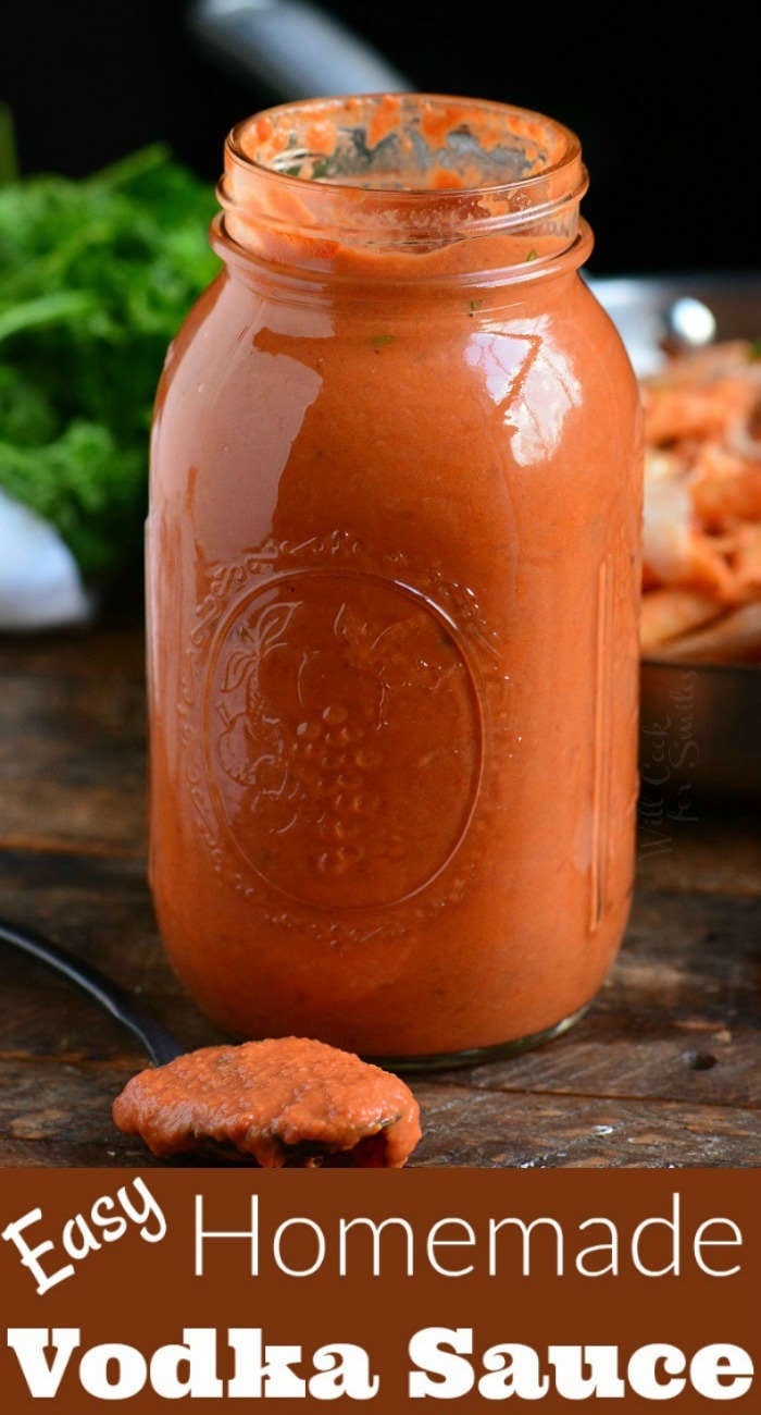 vodka sauce in a glass jar with a spoon full of vodka sauce on a wood board