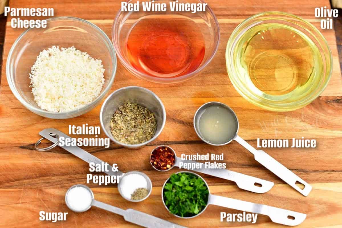 labeled ingredients to make Italian dressing in measured cups on a cutting board.