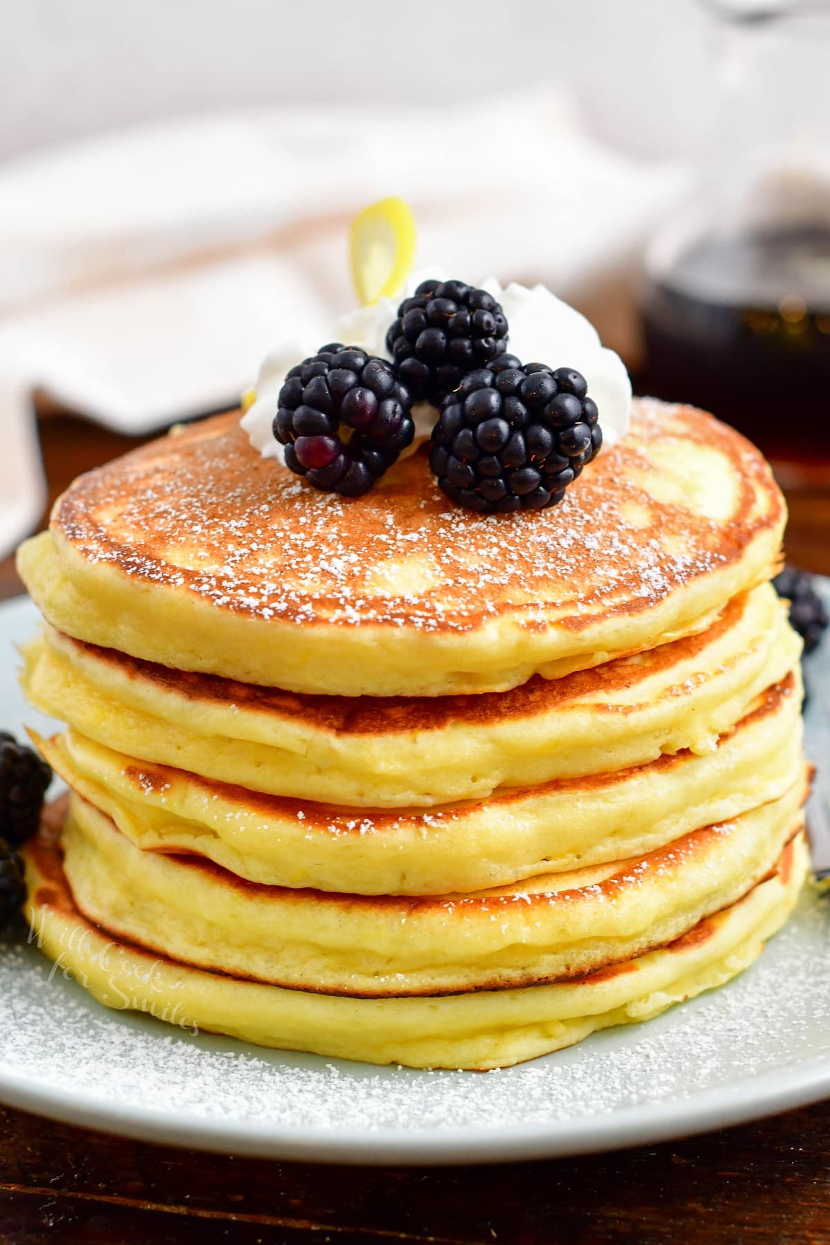 A stack of ricotta pancakes is ready to be eaten.