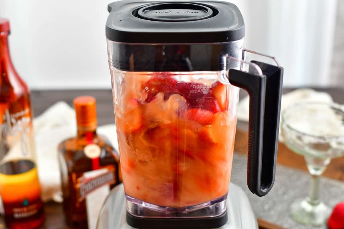 A blender is blending all of the ingredients together.