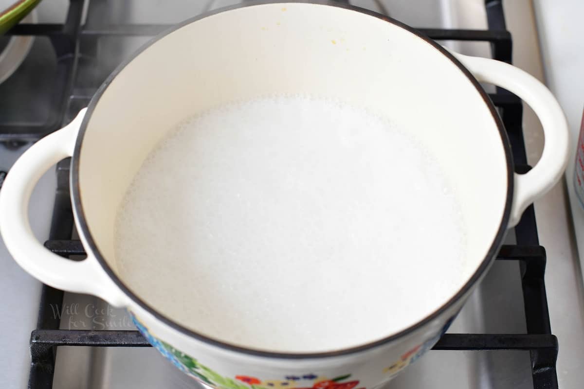 The ingredients, except for rice, are combined in a large pot on the stovetop.