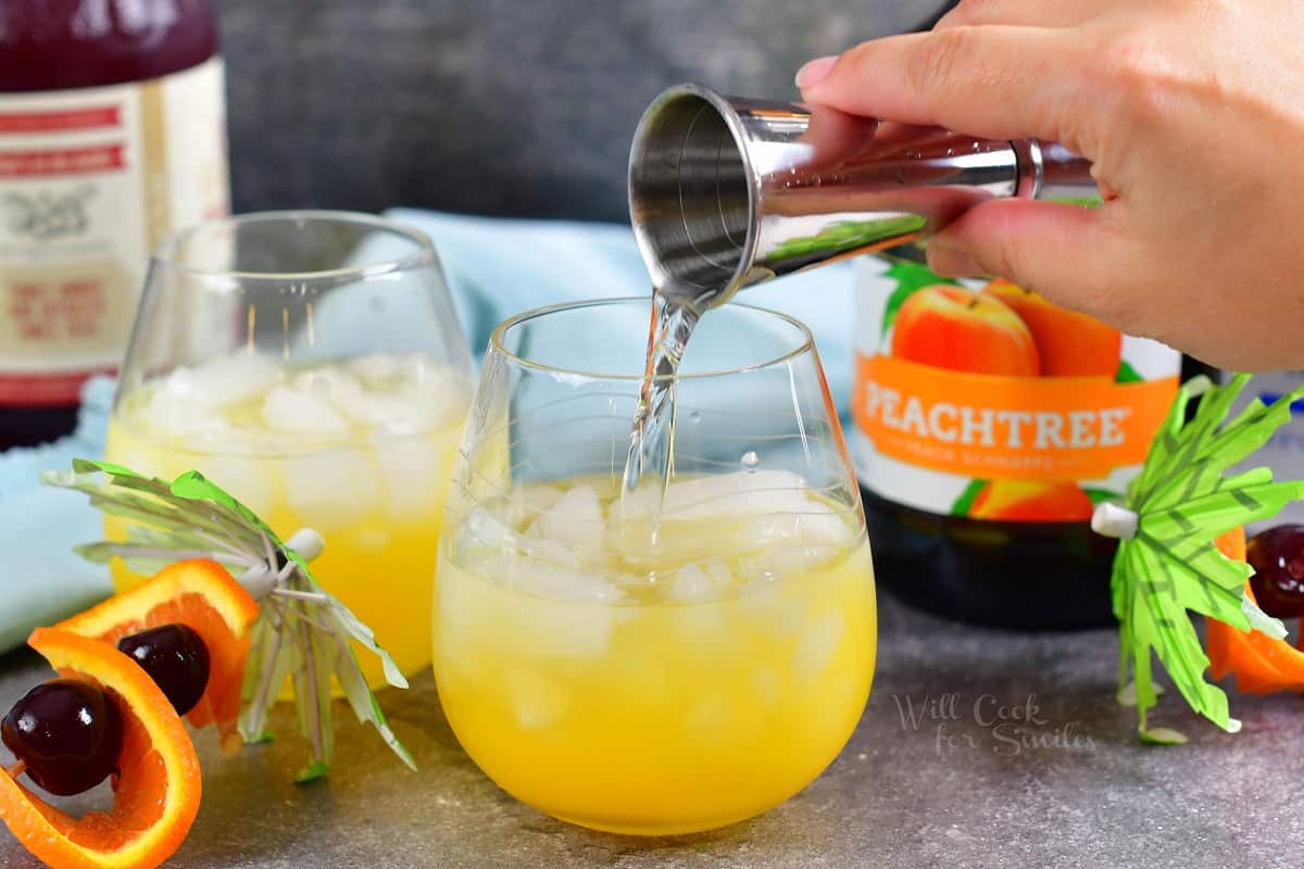 Peach schnapps is being poured into the glass.