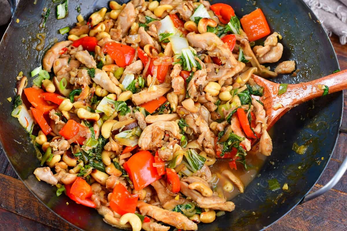 collage of six images of cooking steps to roast cashers, cook chicken and veggies for Thai cashew chicken stir fry.