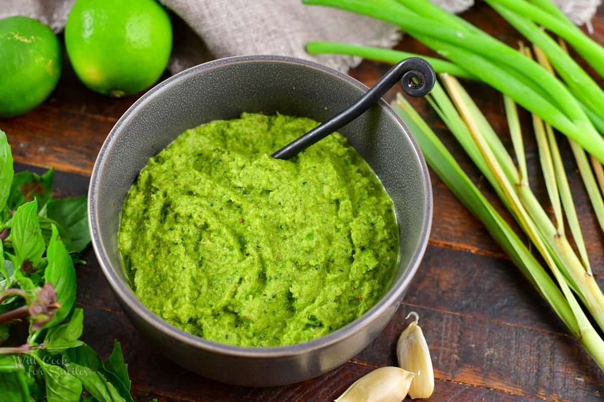 green curry paste in a grey bowl with a spoon