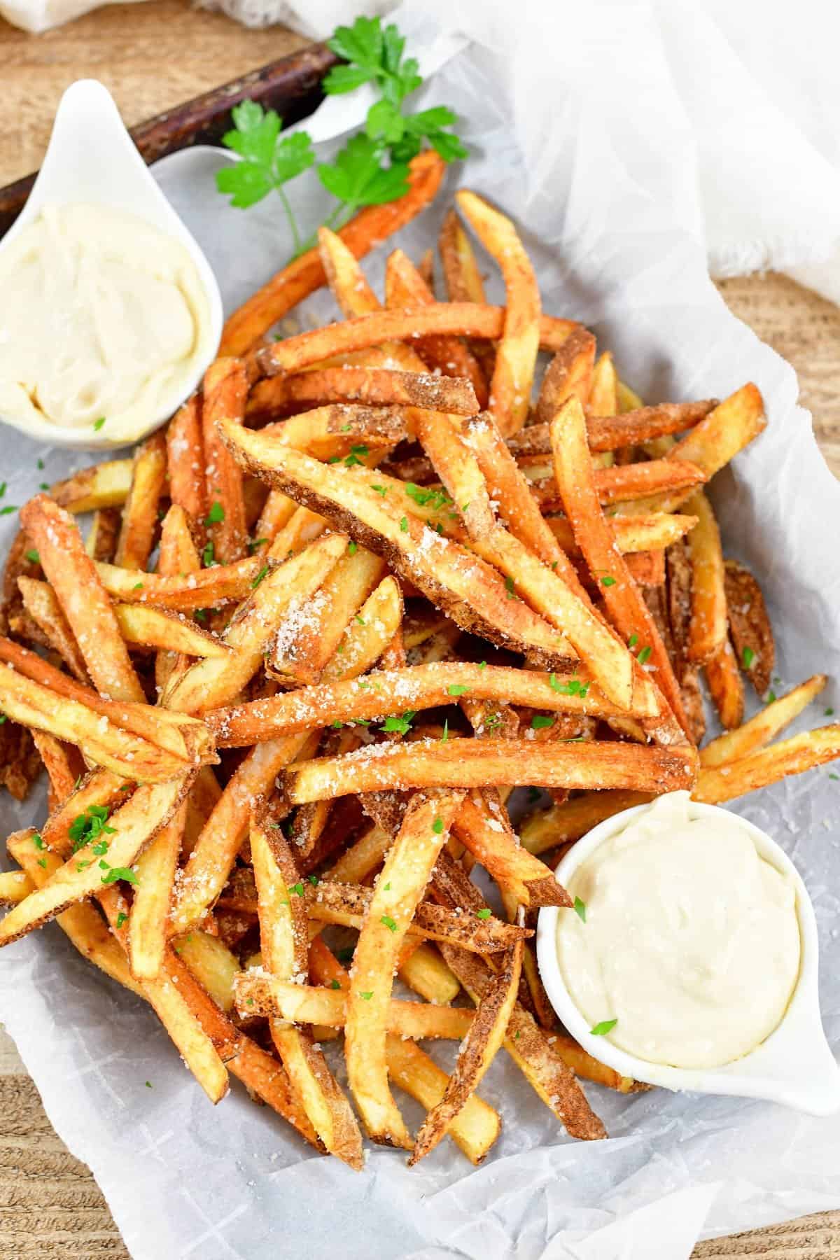 top view of truffle fries with two bowls of aioli
