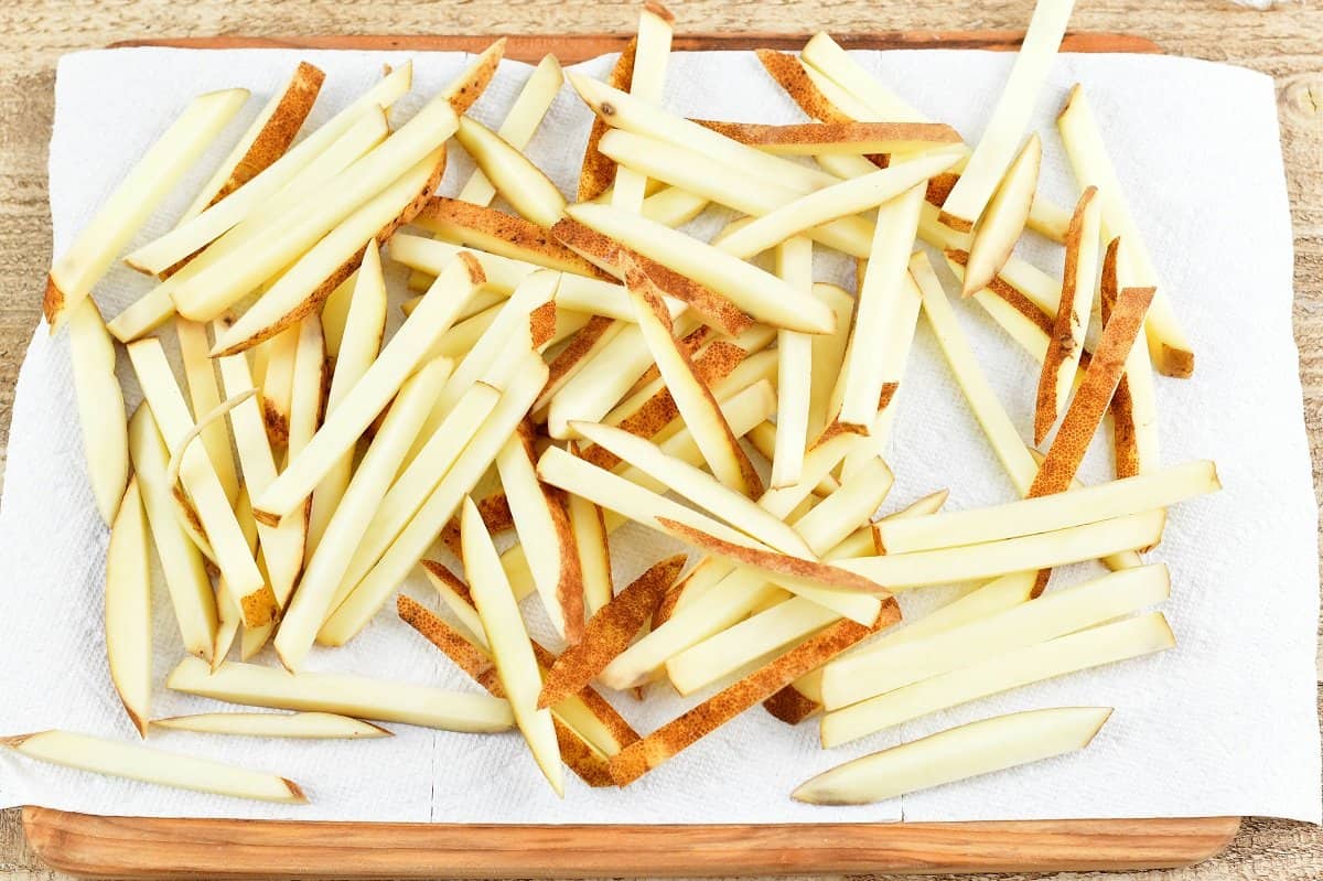raw potatoes sliced into straws and spread on the paper towel