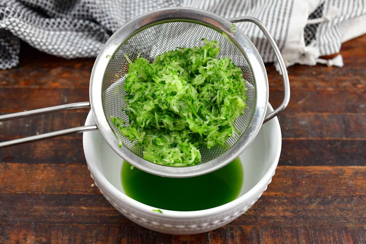 draining the liquid off grated cucumber in mesh strainer