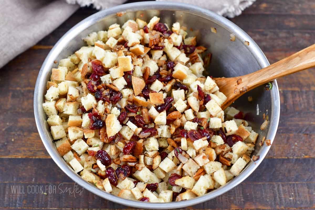 mixing together bread and cranberry nut mixture.