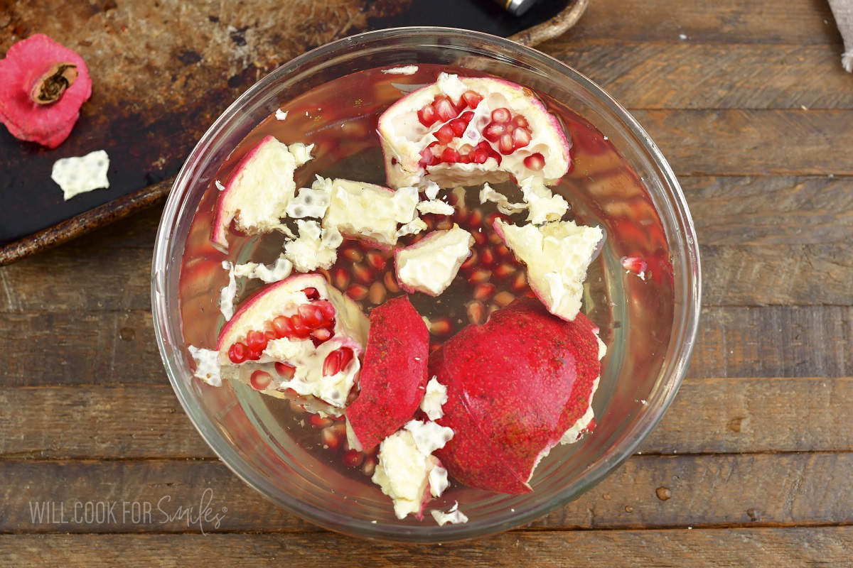 separating pomegranate seeds in water.
