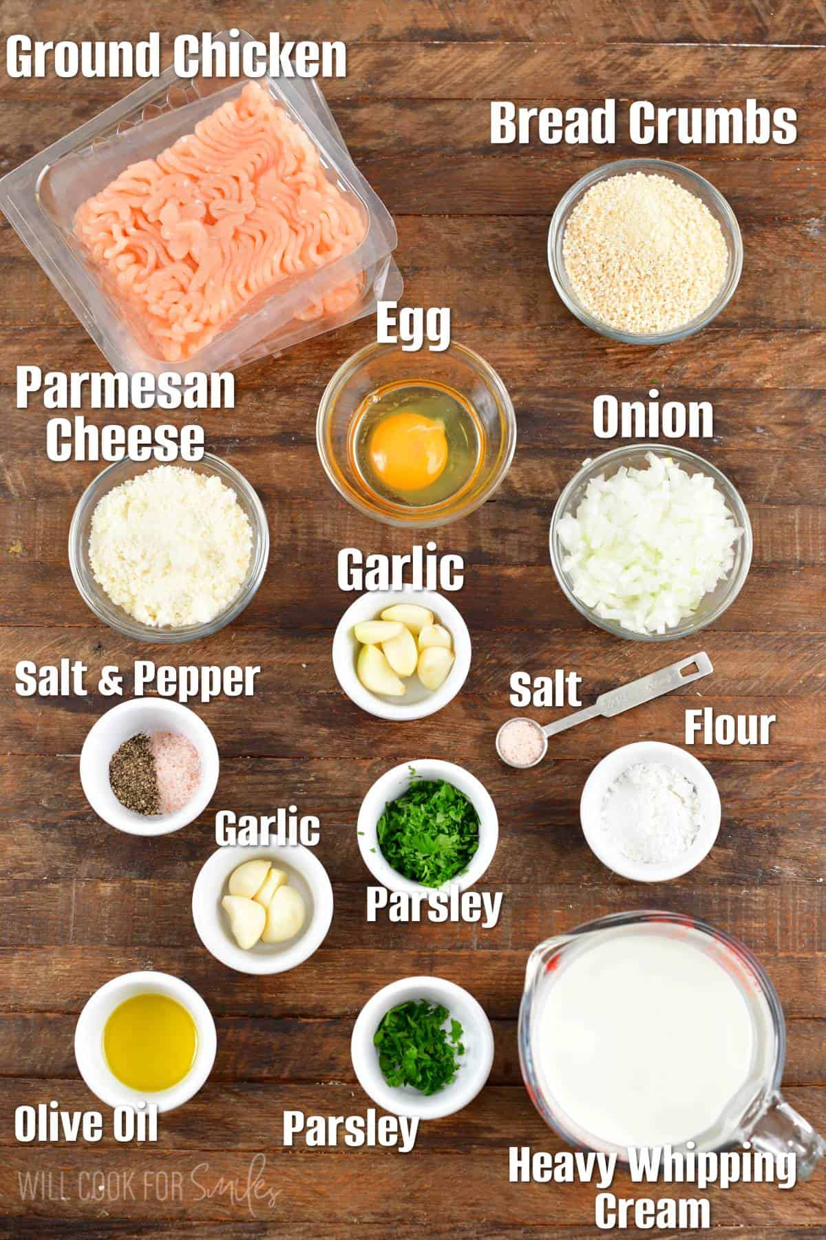 The ingredients for chicken meatloaves are spread out on a wooden surface.