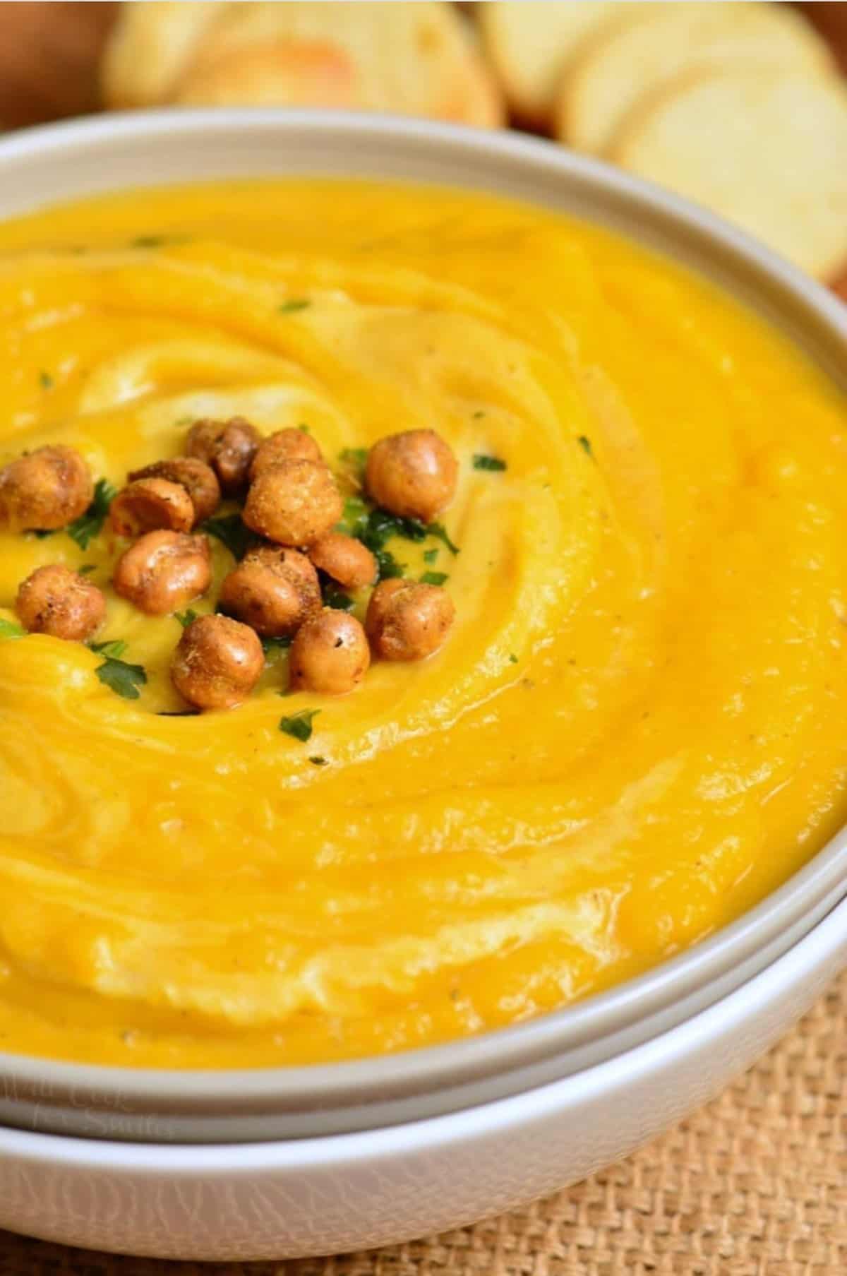 butternut squash soup in a bowl with chickpeas on top.