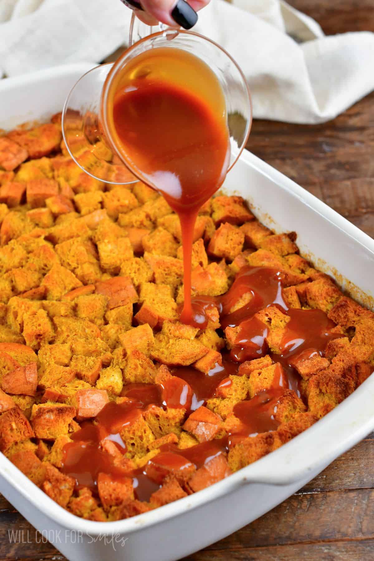 Pouring caramel over the pumpkin bread puffing.