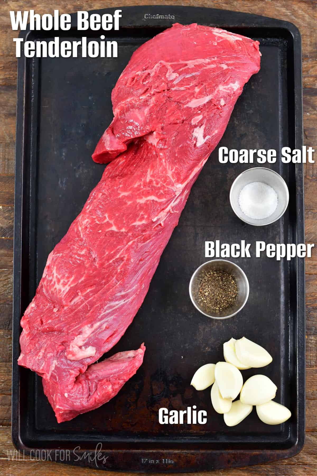 ingredients to make the beet tenderloin on a black baking sheet.