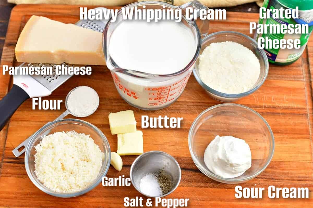 labeled ingredient to make homemade Alfredo sauce on the wooden cutting board.