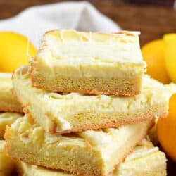 Collage of lemon cheesecake cookie bars cut into squares and staked on top of each other.