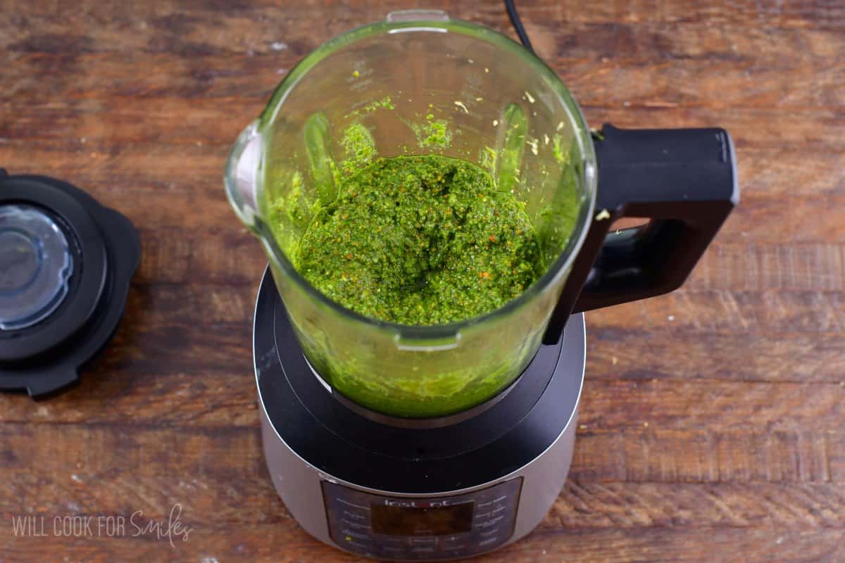 Blending lemon pistachio arugula pesto in a blender.
