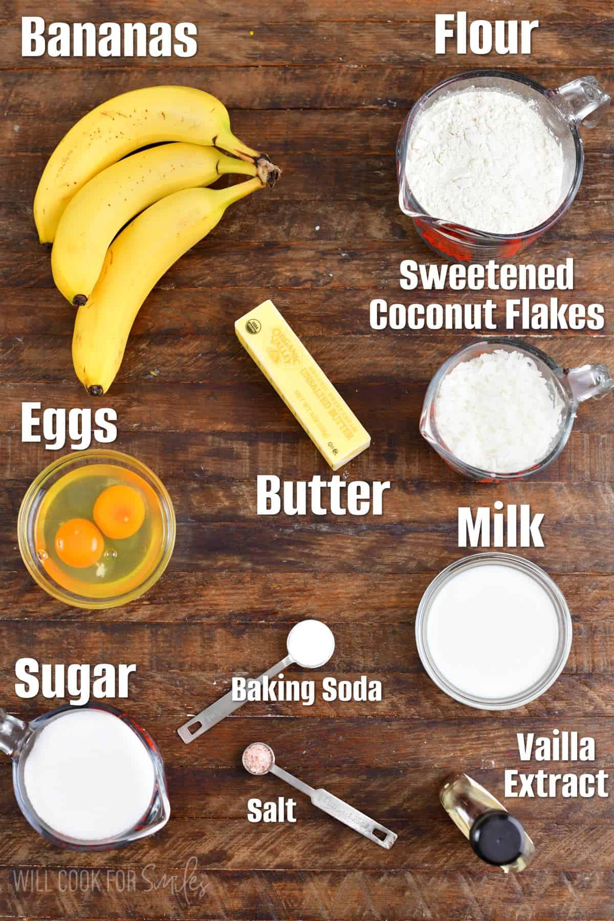 Labeled ingredients for coconut Banana Bread on a wood surface.