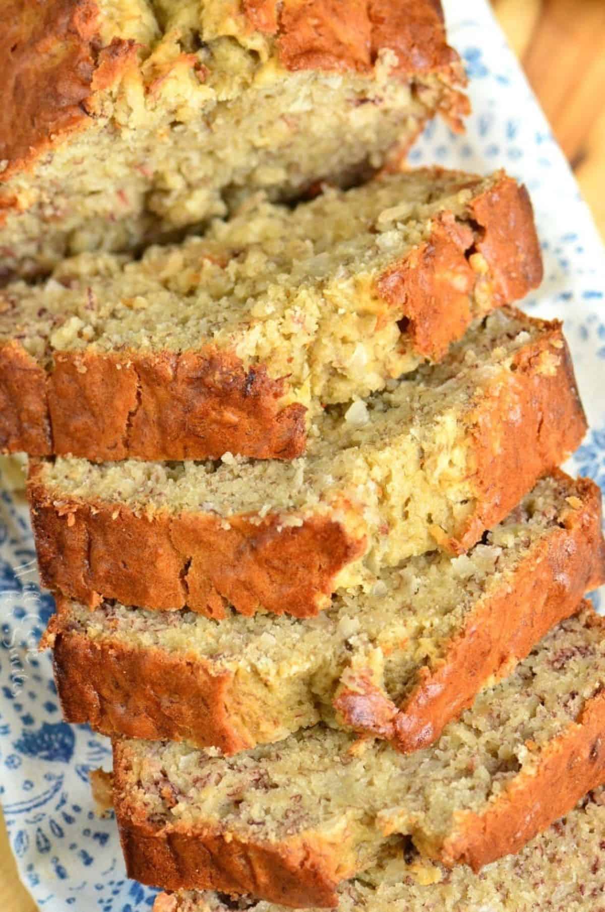 The top of sliced coconut banana bread fanned out on a tea towel.