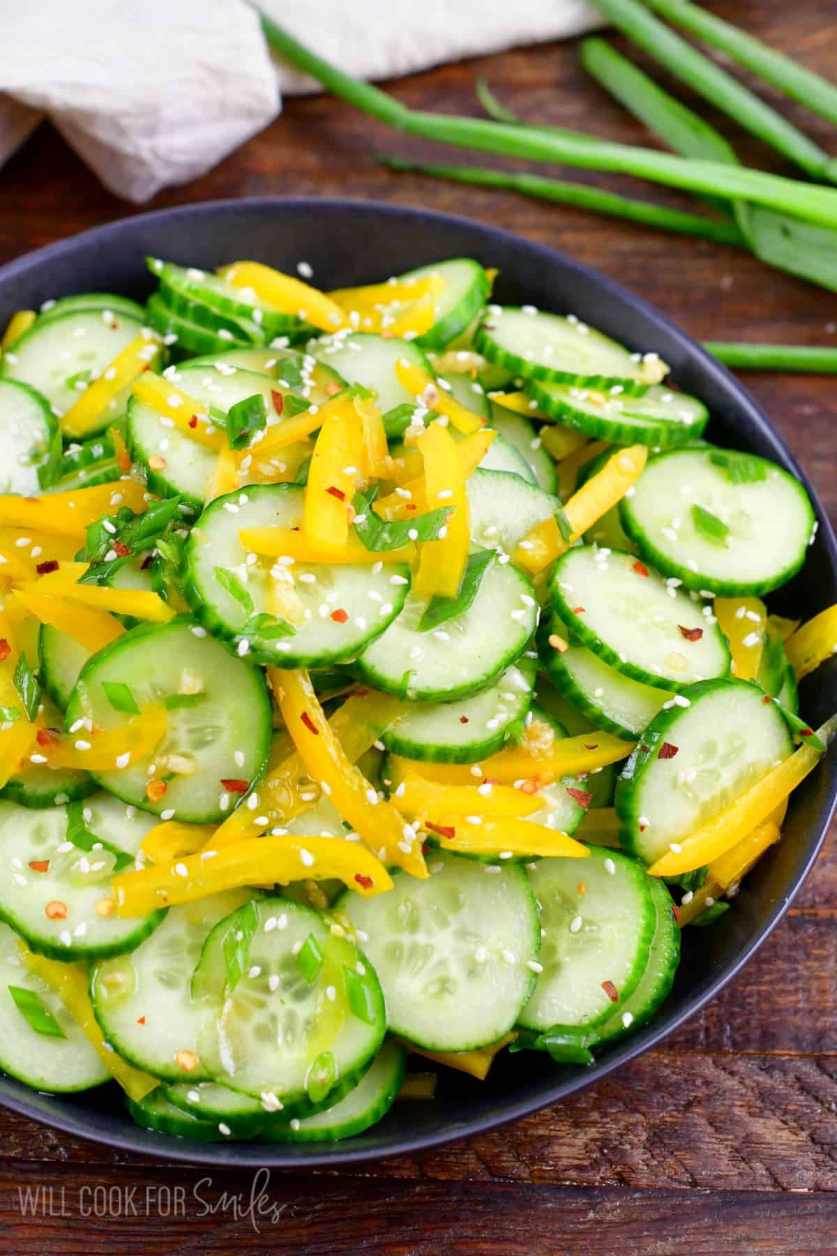 Asian cucumber salad mixed with dressing in a serving bowl.