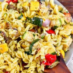 scooping up the Grilled Vegetable pasta salad with a big wooden spoon.