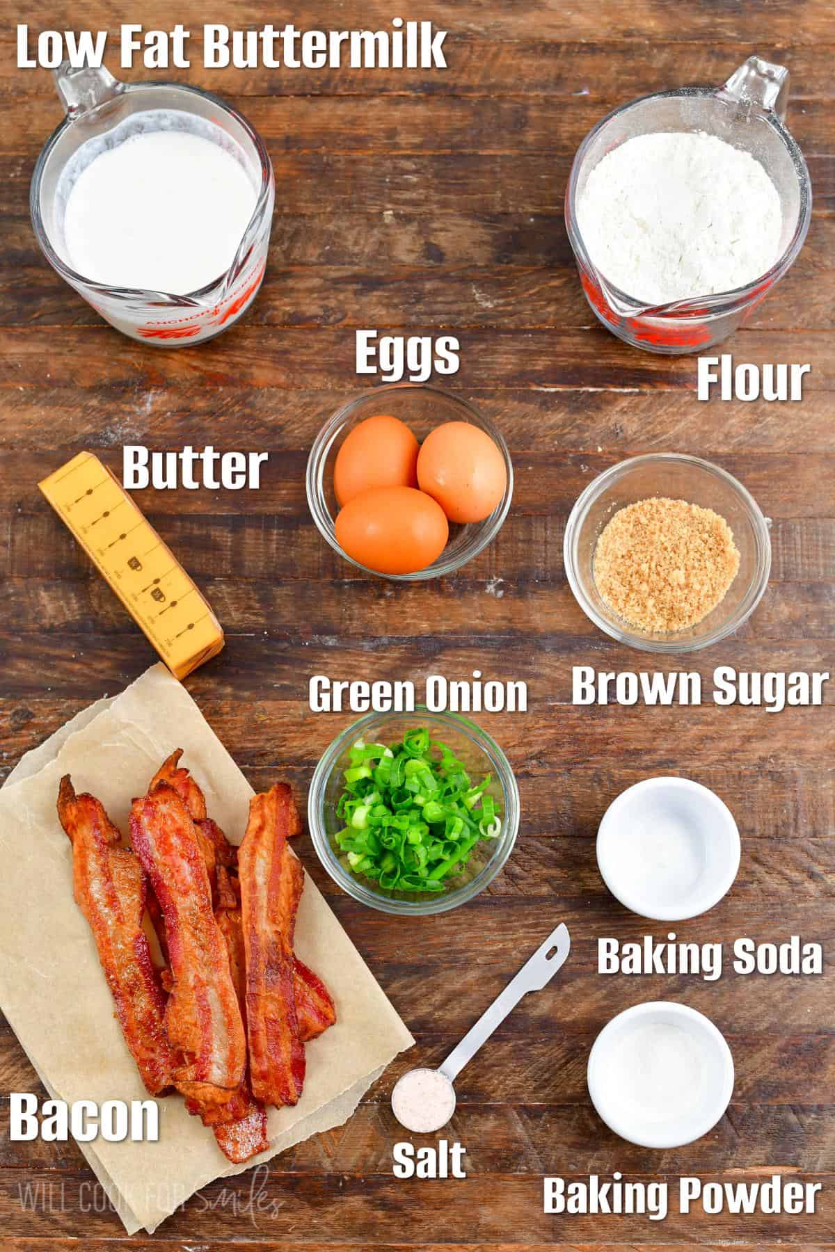 Labeled ingredients for savory waffles on a wood surface.
