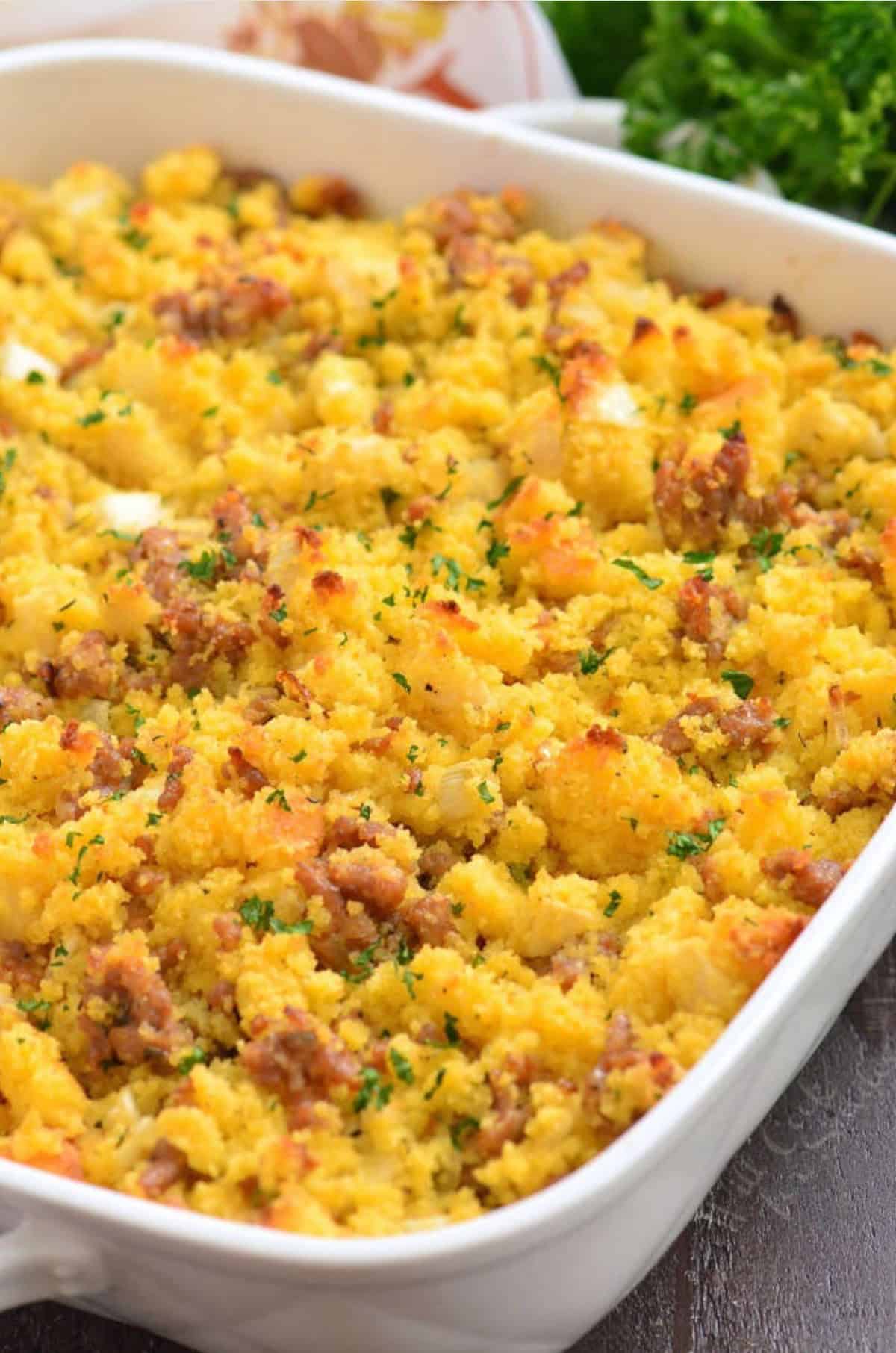 sausage cornbread dressing in the white baking dish.
