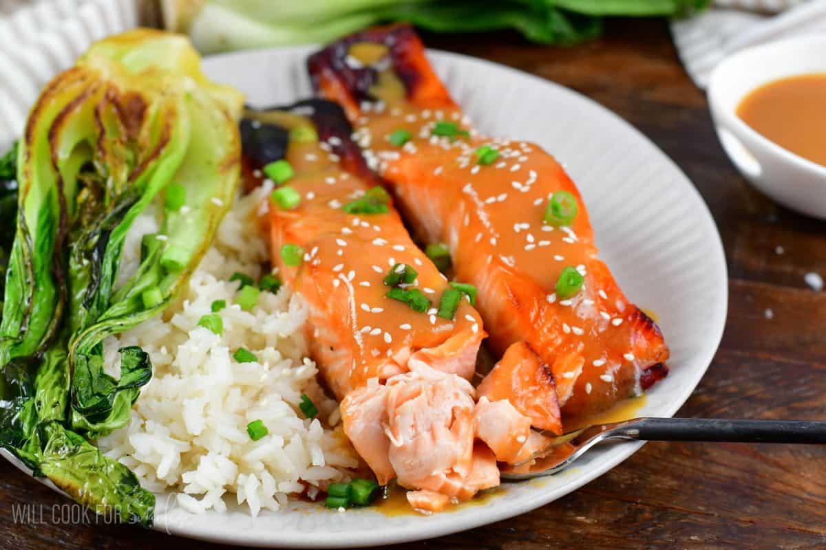 two filets of miso glazed salmon with rice and bok choy.
