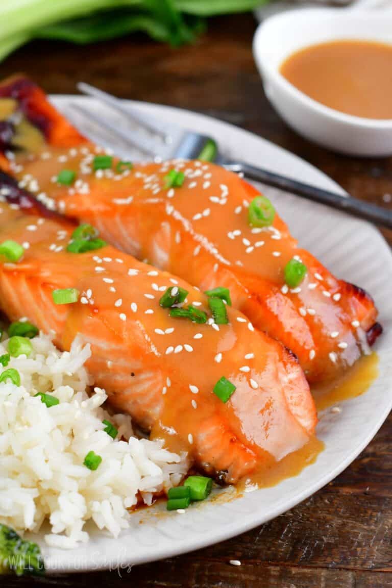 baked salmon with miso glaze topped with sesame seeds and green onion.