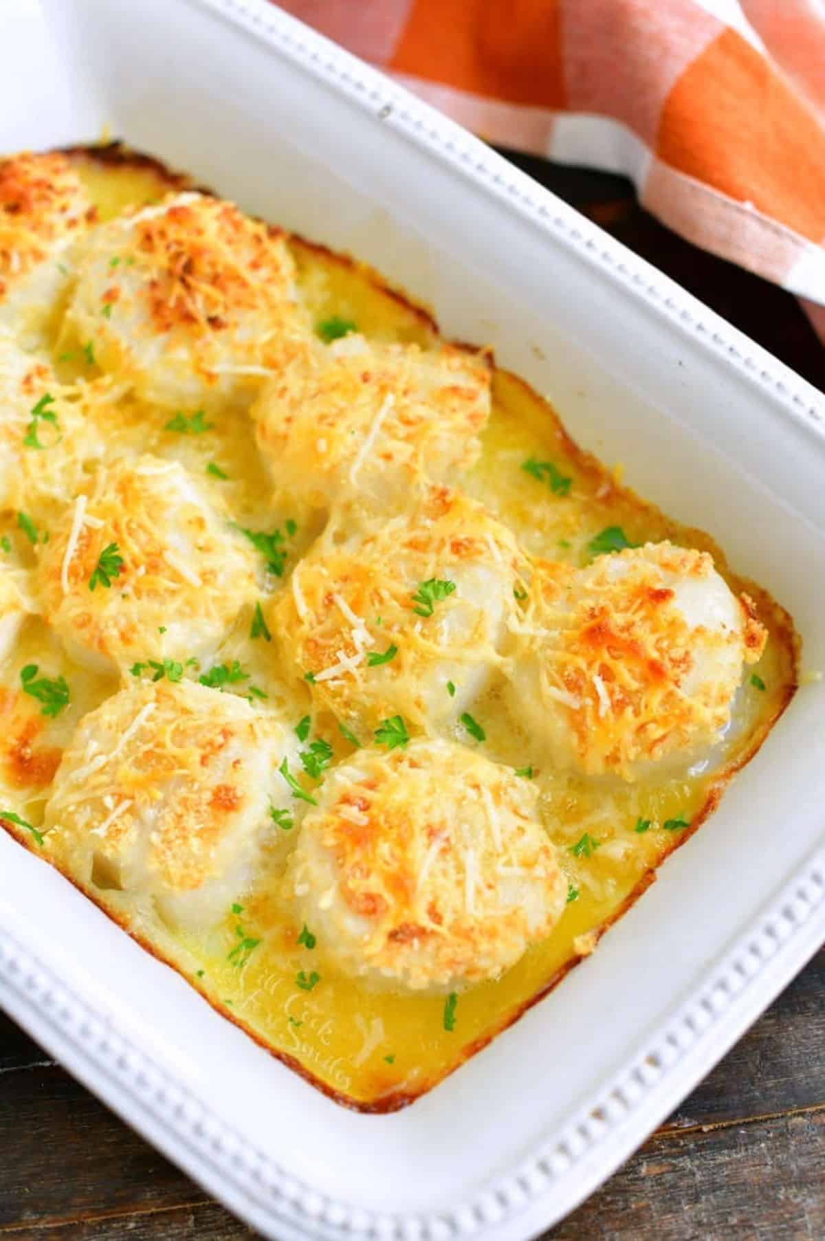 baked scallops topped with parmesan and cooked in butter in the baking dish.