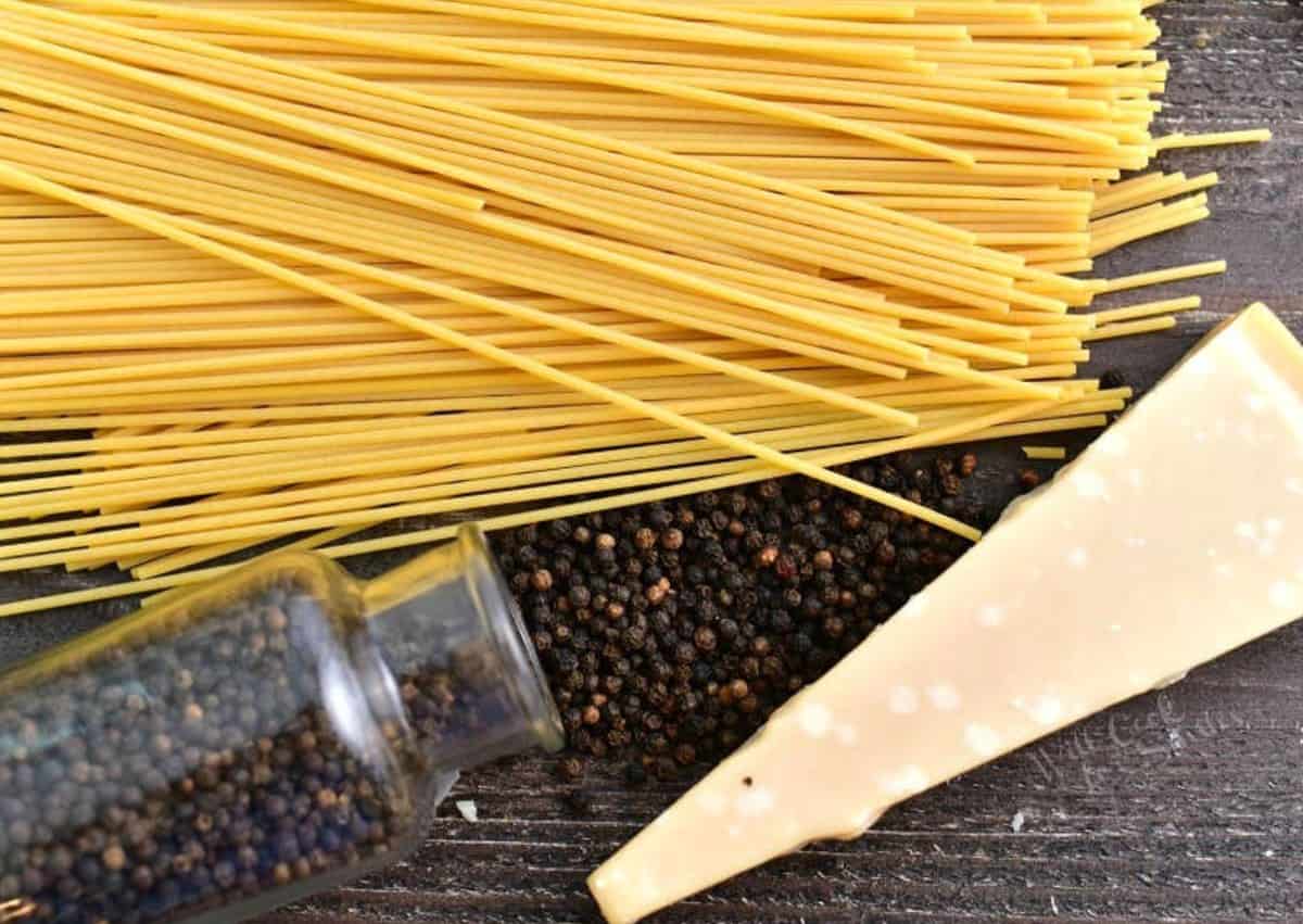 three ingredients to make the cacio e pepe on the wooden board.