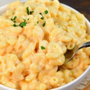a big bowl full and mac and cheese and fork scooping some out.