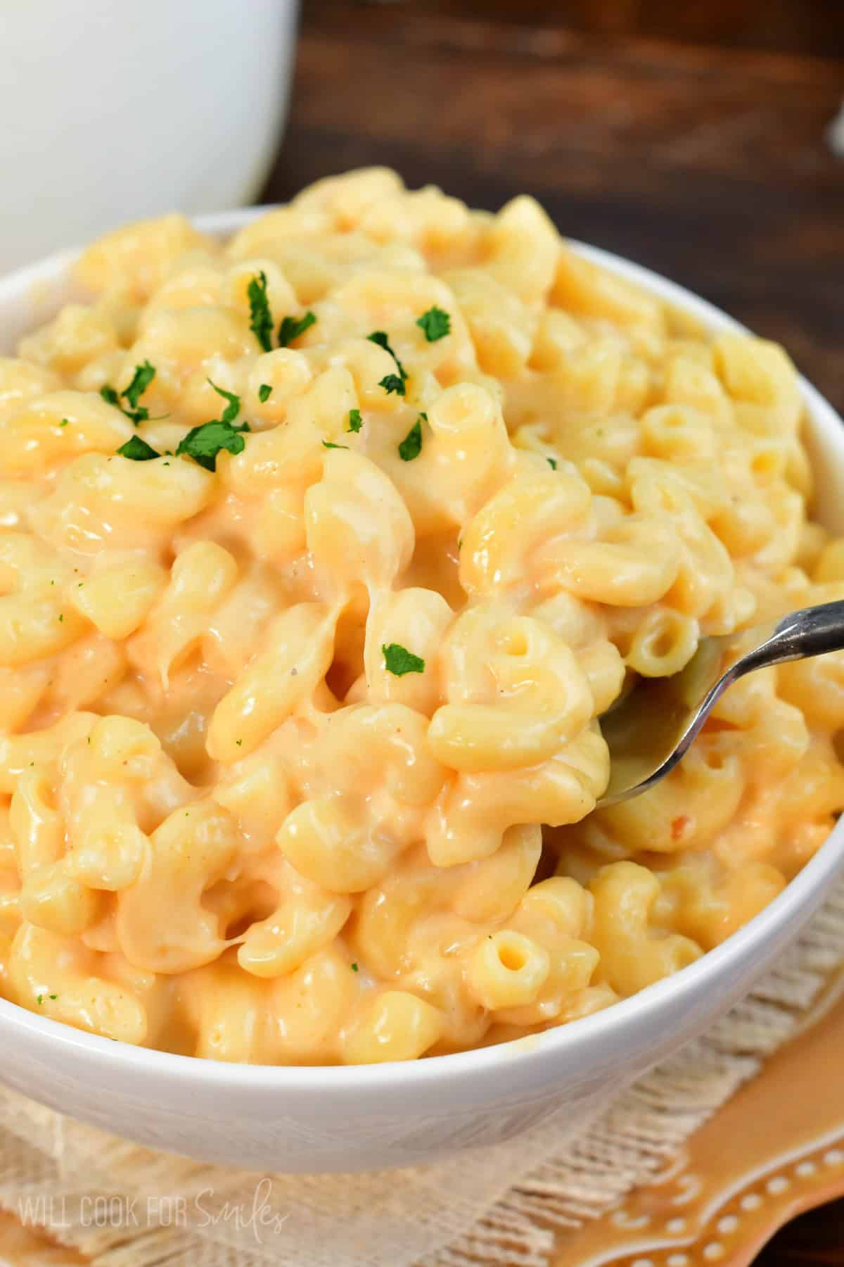 a big bowl full and mac and cheese and fork scooping some out.