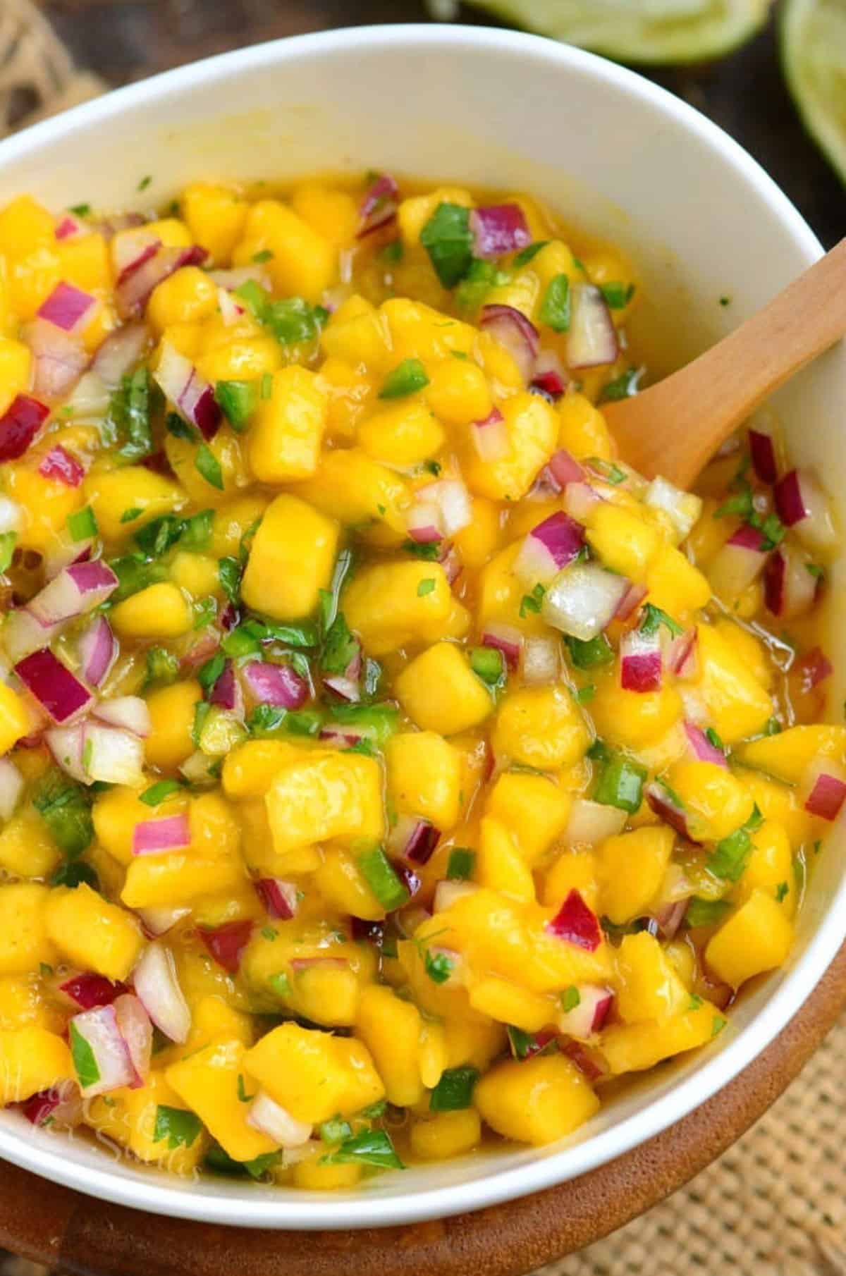 mango salsa with red onion and jalapeno in a bowl.
