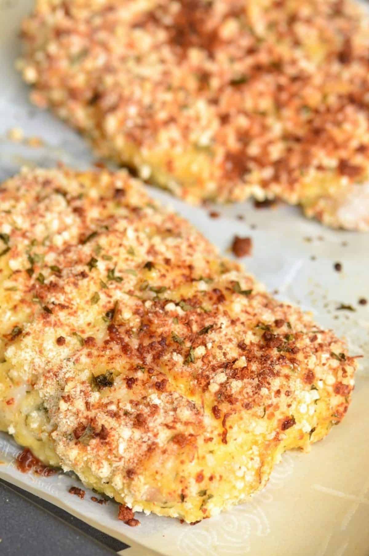 two crispy baked mahi mahi crusted in parmesan and bread crumb mixture.